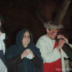 A group of people celebrating Easter in Italy holding a cross.