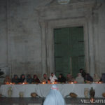 A group of people are sitting around a table celebrating Easter in Italy.