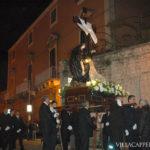 A group of men carrying a casket during Easter in Italy.