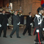 During Easter in Italy, a group of men solemnly carry a casket.