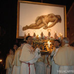 A group of priests carrying a large statue of Jesus during Easter in Italy.