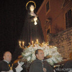 A group of priests carrying a statue during Easter in Italy.