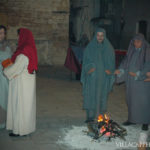 A group of people celebrating Easter in Italy, standing around a fire.