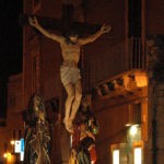 A statue of Jesus on a cross, symbolizing Easter traditions in Italy.