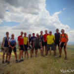 A group of cyclists on an Italian bike tour standing on top of a hill.