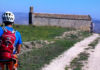 010: Italian bike tour A man on an Italian bike tour riding down a dirt road.
