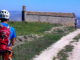 010: Italian bike tour A man on an Italian bike tour riding down a dirt road.