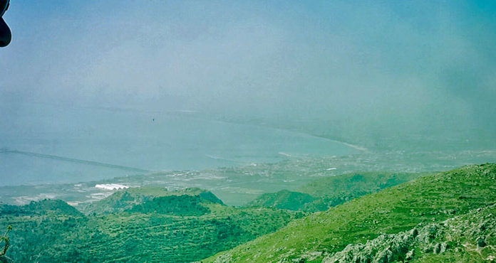 008: Travel with us to the Gargano A man gazing out of a window at a majestic mountain in Gargano.