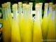 Villa Cappelli Limoncello A collection of bottles containing yellow liquid, inviting you to travel and explore the scenic Gargano region with us.