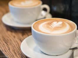 Italian Travel Tip: Cappuccino Two Italian cappuccinos on a wooden table.