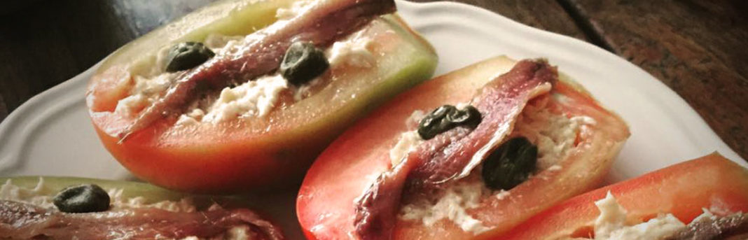 No-cook recipe of stuffed tomatoes with olives and capers, perfect for beating the heat during a Summer in Italy.