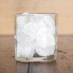 Italian Travel Tip: Enjoy a refreshing glass of ice-cold water on a wooden table.