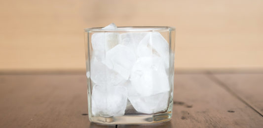 Italian Travel Tip: Ice Italian Travel Tip: Enjoy a refreshing glass of ice-cold water on a wooden table.