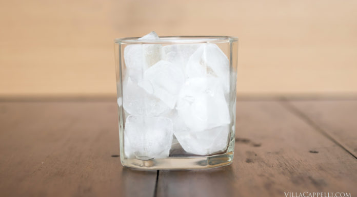 Italian Travel Tip: Ice Italian Travel Tip: Enjoy a refreshing glass of ice-cold water on a wooden table.