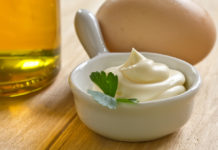 Extra Virgin Olive Oil Mayo A bowl of sour cream and MAYO on a wooden table.